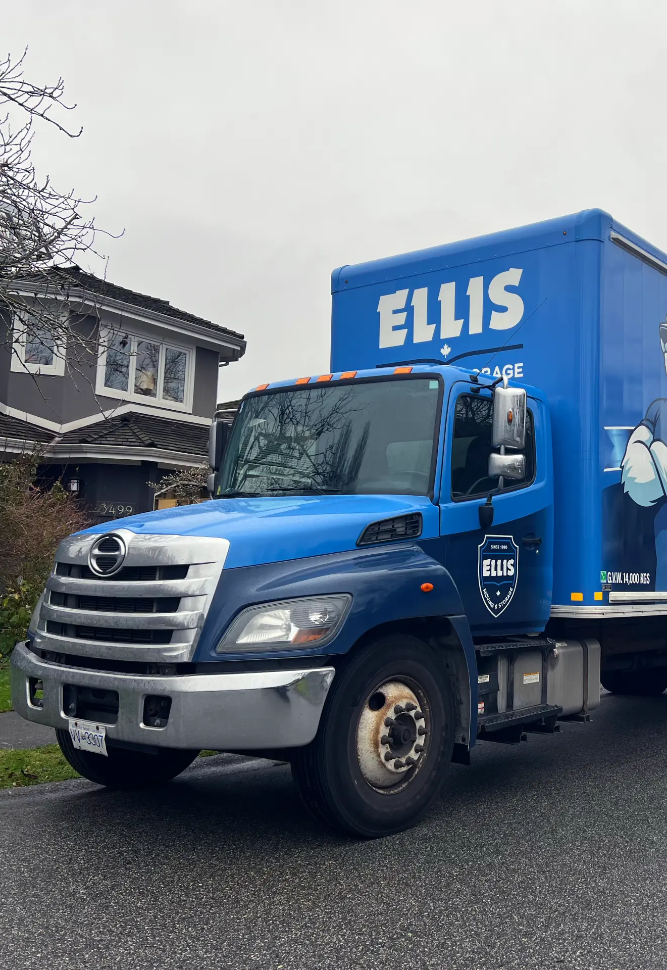 An Ellis Moving & Storage truck parked outside a home on move day